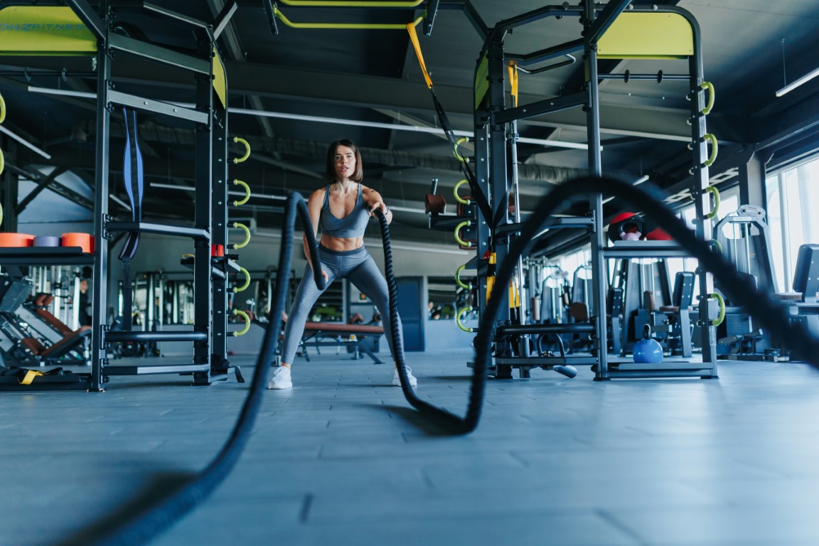 young adults athletes, gather at the gym to engage in a rigorous rope workout, emphasizing their commitment to physical fitness. Group Fitness Athleticism and Sportswear Shine